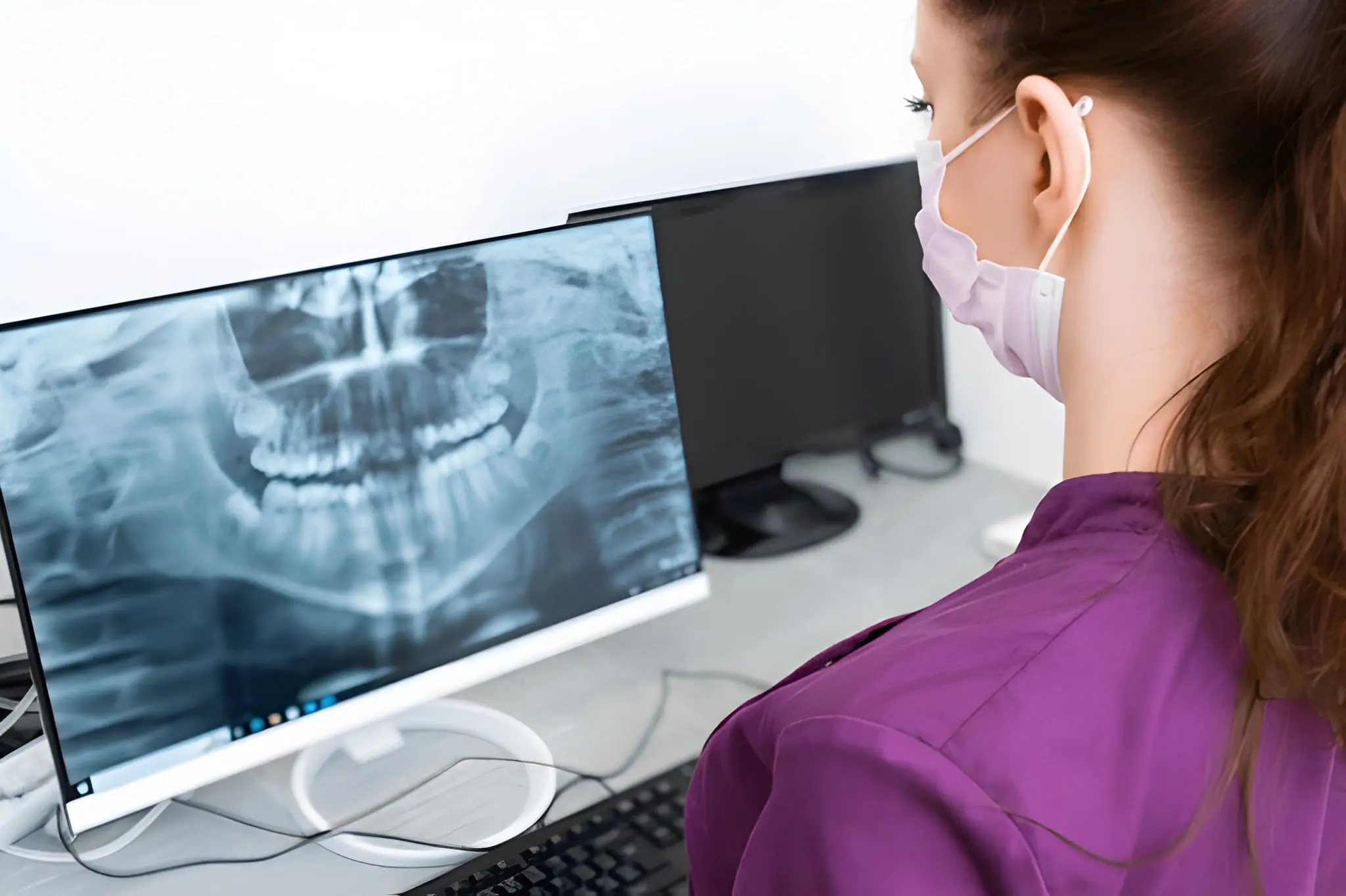 Dental exam in Flower Mound TX dentist reviewing panoramic dental X-ray at Supreme Smiles Dentistry