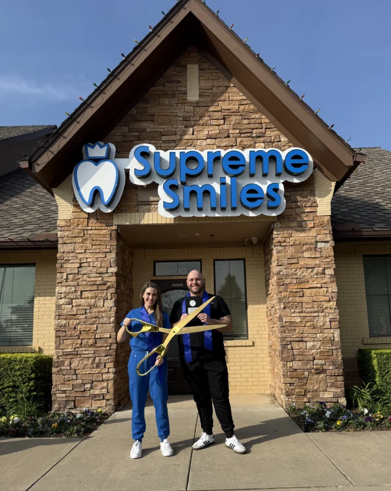 Dr. Hadeel Saleh and Dr. Amjad Saleh holding scissor for ribbon cutting